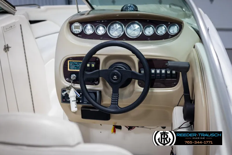 Slide: The Image of 2002 Chaparral 243 Sunesta boat dashboard with steering wheel and control panel. - 23