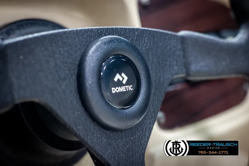 Slide: The Image of Steering wheel of 2002 Chaparral 243 Sunesta boat with Dometic logo. - 26