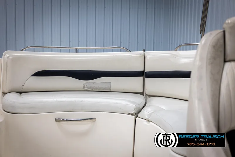 Slide: The Image of 2002 Chaparral 243 Sunesta boat interior with white seating and visible wear. - 37