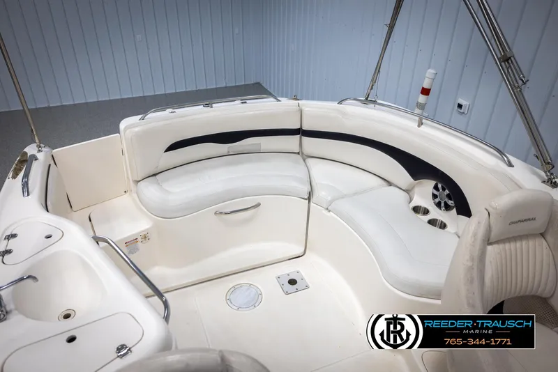 Slide: The Image of 2002 Chaparral 243 Sunesta boat interior with white seating and cup holders. - 44