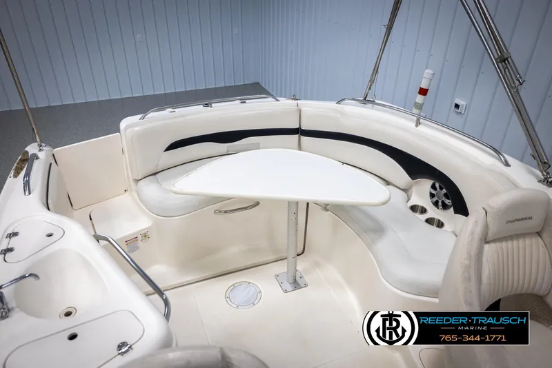 Slide: The Image of 2002 Chaparral 243 Sunesta boat interior with seating and table setup. - 45