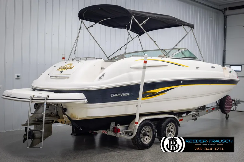 Slide: The Image of Chaparral 243 Sunesta 2002 boat on trailer in indoor storage facility. - 6