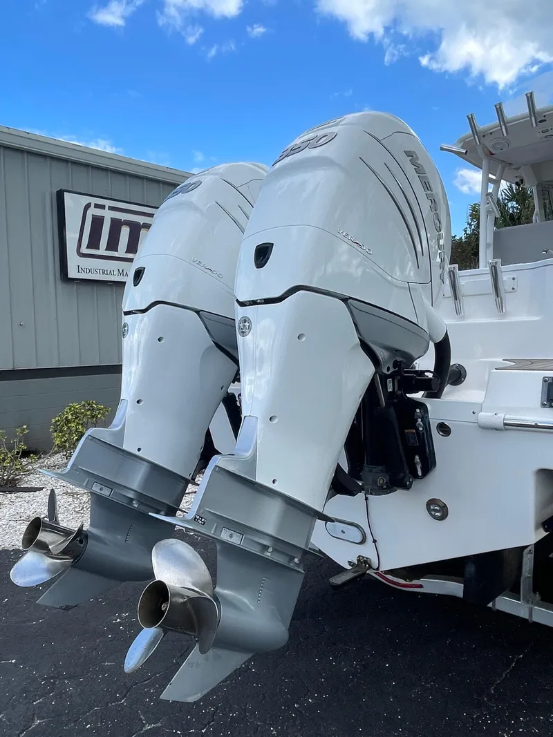 Slide: The Image of 2014 Everglades 325 Center Console with dual outboard motors, docked outdoors. - 10