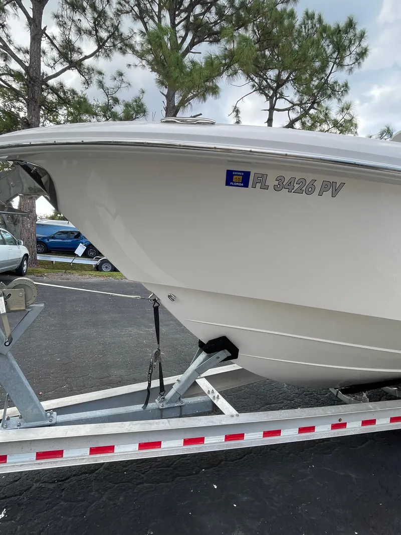 Slide: The Image of 2014 Everglades 325 Center Console boat on trailer, parked outdoors. - 14