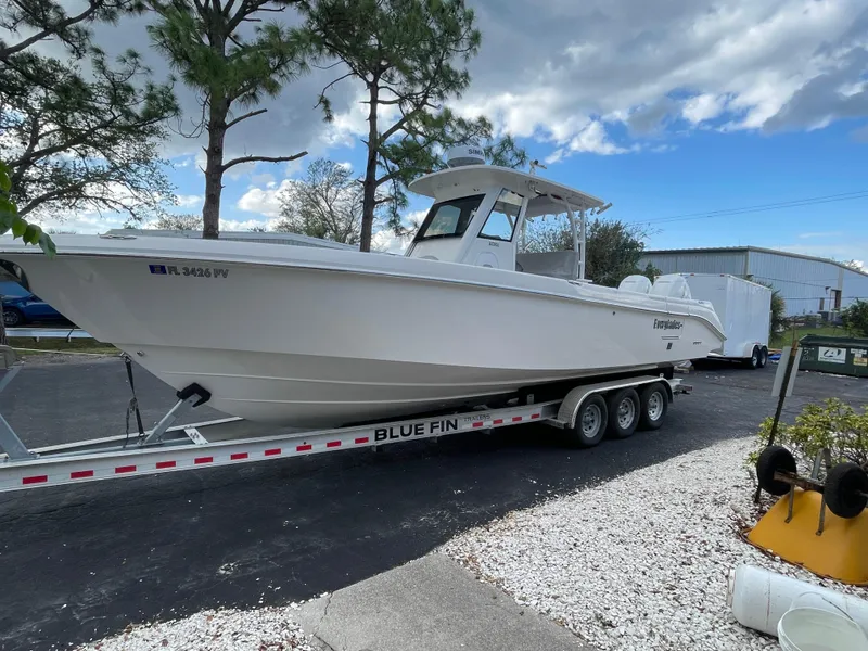 Slide: The Image of 2014 Everglades 325 Center Console boat on trailer, parked outdoors. - 15