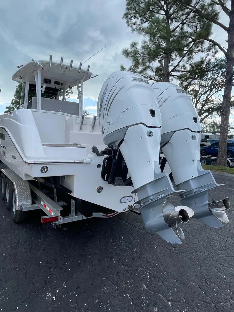 Slide: The Image of 2014 Everglades 325 Center Console boat with dual outboard engines on a trailer. - 17