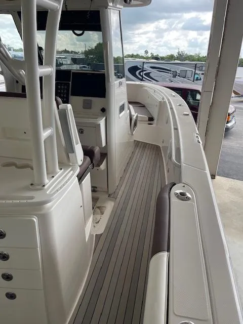 Slide: The Image of 2014 Everglades 325 Center Console boat interior with helm and seating area. - 29