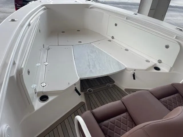 Slide: The Image of 2014 Everglades 325 Center Console boat interior with seating and storage compartments. - 31