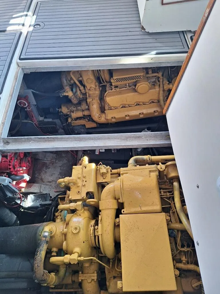 Slide: The Image of 1985 Sea Ray 390 Express Cruiser engine compartment with visible machinery. - 18