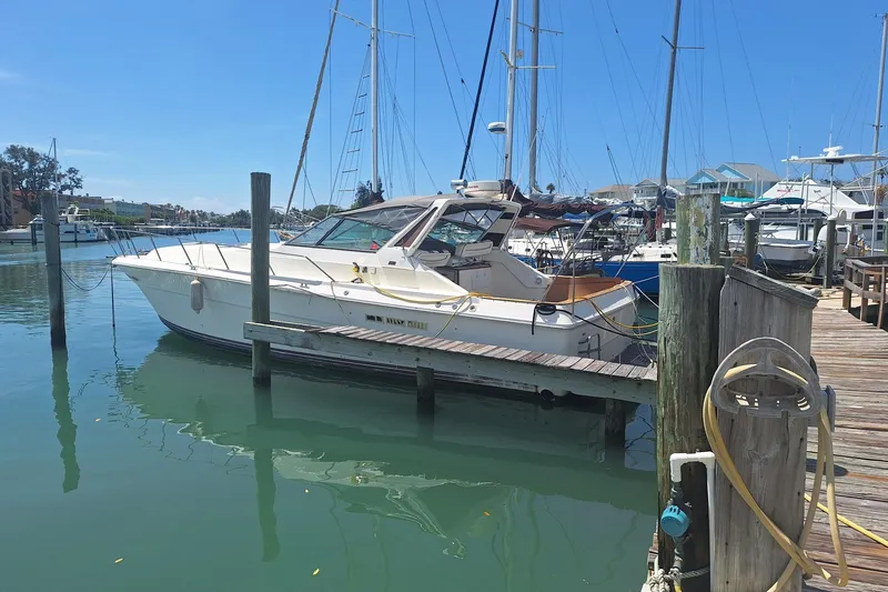 Slide: The Image of 1985 Sea Ray 390 Express Cruiser docked at a marina on a sunny day. - 7