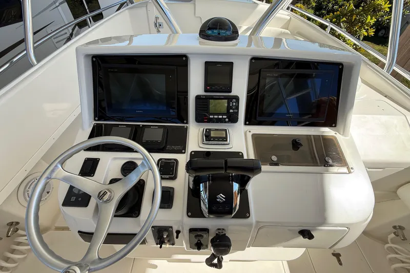 Slide: The Image of 2008 Intrepid 377 Walkaround helm with dual screens, steering wheel, and control panel. - 102