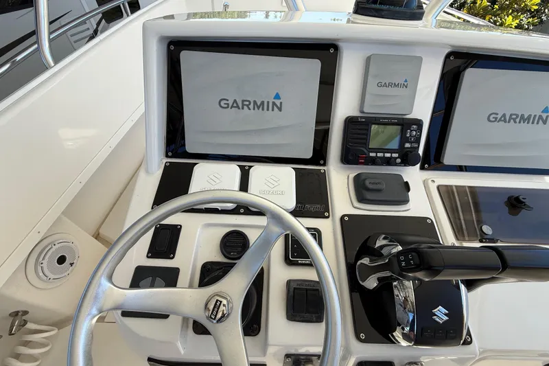 Slide: The Image of 2008 Intrepid 377 Walkaround helm with Garmin displays and Suzuki controls. - 104