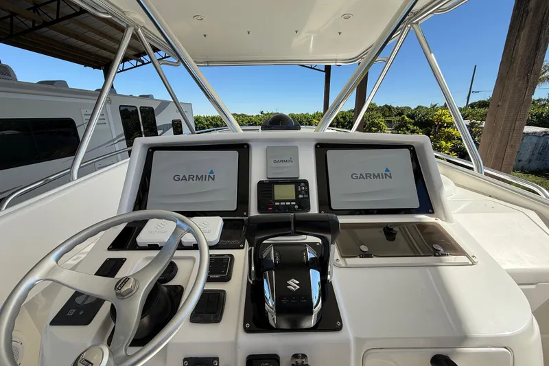 Slide: The Image of Helm of 2008 Intrepid 377 Walkaround with Garmin navigation displays and Suzuki controls. - 106