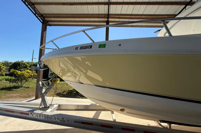 Slide: The Image of 2008 Intrepid 377 Walkaround boat on trailer under a metal canopy. - 11