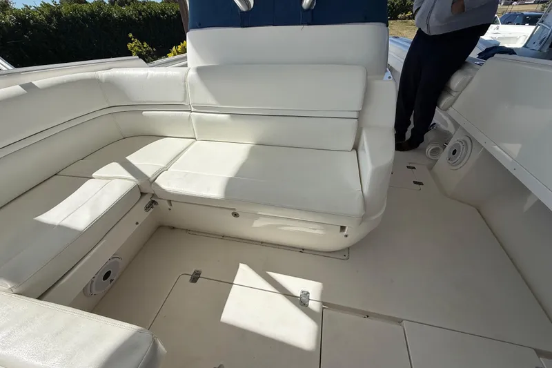 Slide: The Image of 2008 Intrepid 377 Walkaround boat interior with white seating and spacious deck area. - 116