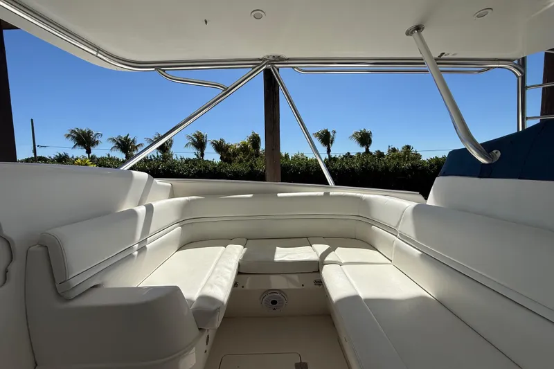 Slide: The Image of 2008 Intrepid 377 Walkaround boat interior with white seating and sunny outdoor view. - 118