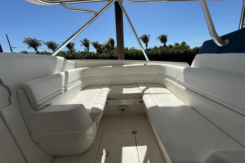 Slide: The Image of 2008 Intrepid 377 Walkaround boat interior with white seating and palm trees in the background. - 119