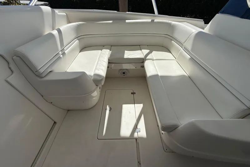 Slide: The Image of 2008 Intrepid 377 Walkaround boat interior with white cushioned seating. - 120