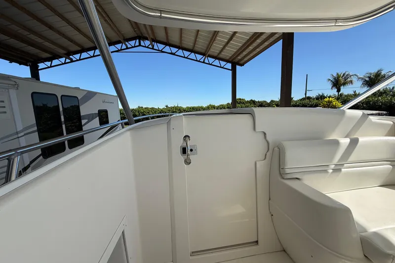 Slide: The Image of 2008 Intrepid 377 Walkaround boat interior with seating and railing under a canopy. - 122