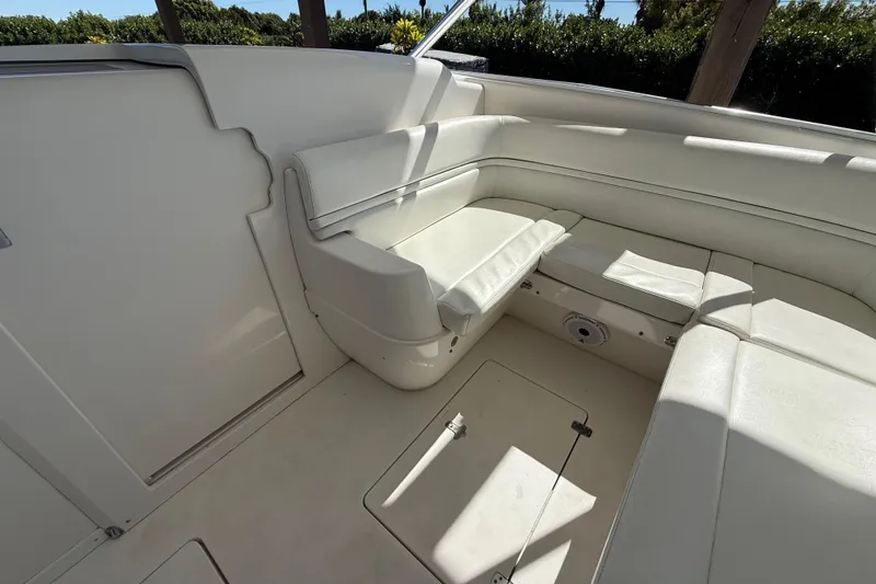 Slide: The Image of 2008 Intrepid 377 Walkaround boat interior with white seating and storage compartments. - 123