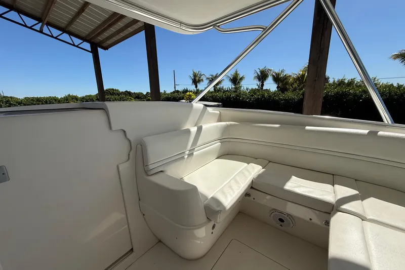 Slide: The Image of 2008 Intrepid 377 Walkaround boat interior with white seating under a canopy. - 124