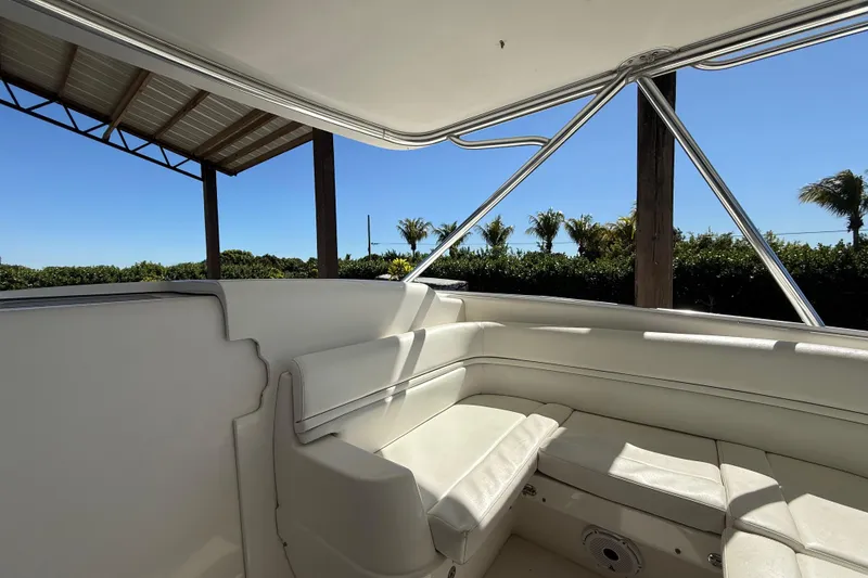 Slide: The Image of 2008 Intrepid 377 Walkaround boat interior with white seating and sunny outdoor view. - 125