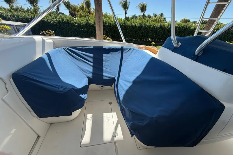 Slide: The Image of 2008 Intrepid 377 Walkaround boat seating area with blue covers and stainless steel railings. - 127