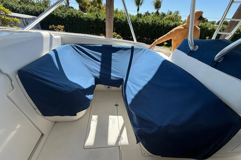 Slide: The Image of 2008 Intrepid 377 Walkaround boat interior with blue-covered seating area. - 128