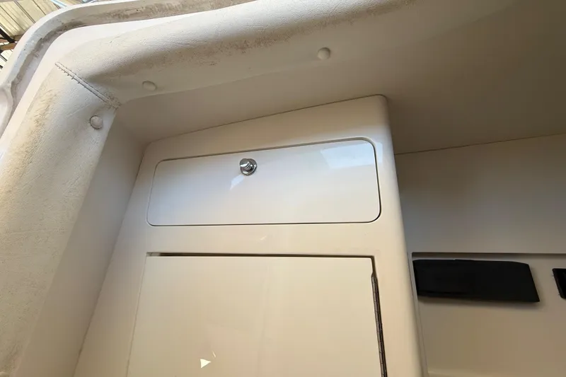Slide: The Image of 2008 Intrepid 377 Walkaround interior storage compartment with sleek white finish. - 129