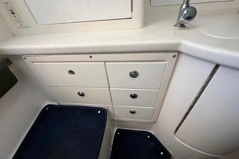 Slide: The Image of 2008 Intrepid 377 Walkaround interior with white cabinetry and blue carpet. - 131