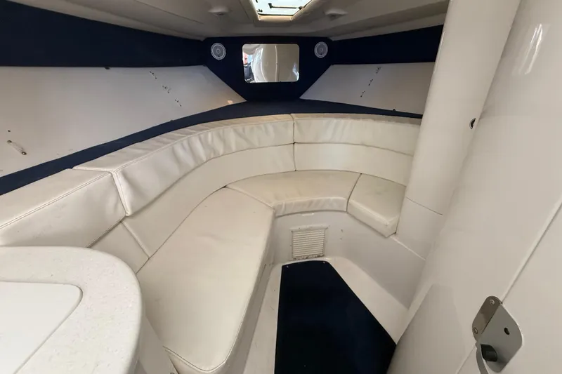 Slide: The Image of Interior of 2008 Intrepid 377 Walkaround boat with white seating and blue accents. - 136