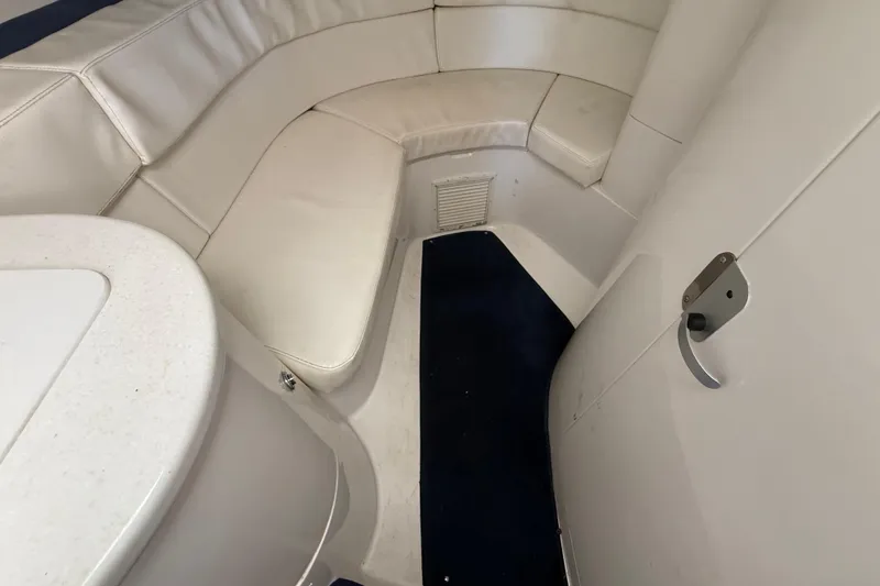 Slide: The Image of 2008 Intrepid 377 Walkaround cabin interior with white seating and blue carpet. - 137