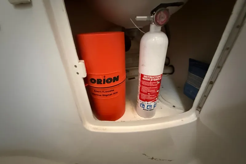 Slide: The Image of Orion marine signal kit and fire extinguisher in 2008 Intrepid 377 Walkaround storage compartment. - 141