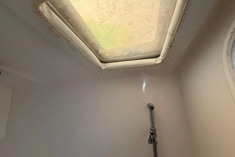 Slide: The Image of Interior view of 2008 Intrepid 377 Walkaround boat, featuring a skylight and shower fixture. - 147