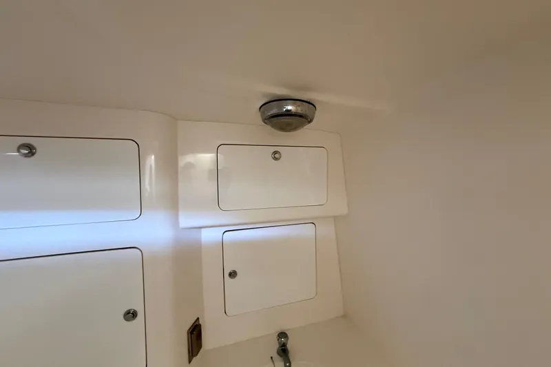 Slide: The Image of 2008 Intrepid 377 Walkaround cabin interior with storage compartments and light fixture. - 150