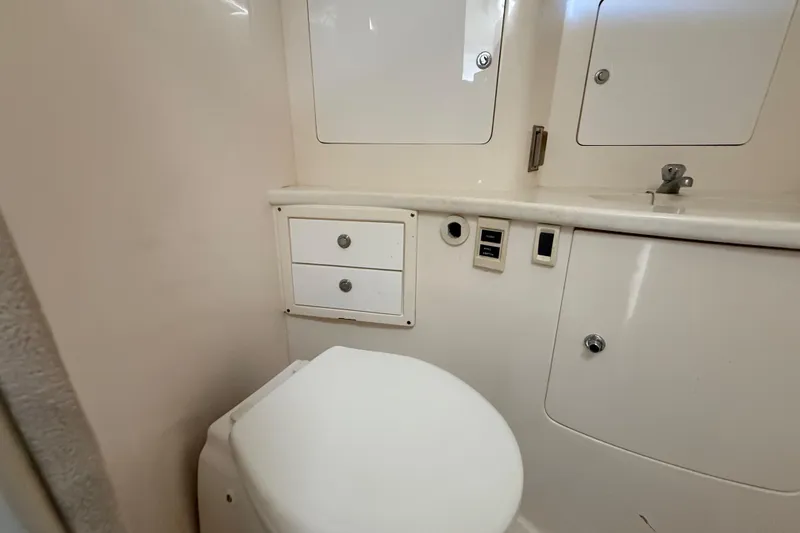 Slide: The Image of 2008 Intrepid 377 Walkaround bathroom with white fixtures and storage cabinets. - 151