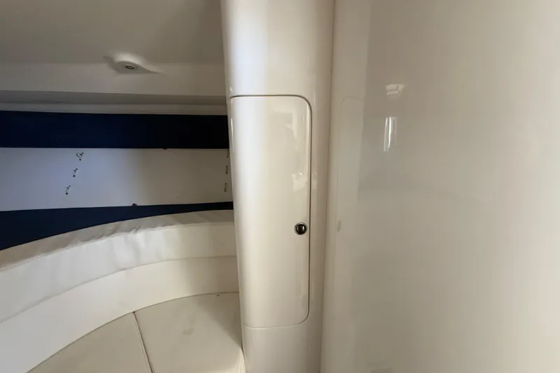 Slide: The Image of Interior of 2008 Intrepid 377 Walkaround boat, featuring sleek white design and storage compartment. - 156