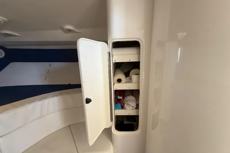 Slide: The Image of Storage compartment inside 2008 Intrepid 377 Walkaround boat, containing various supplies. - 157