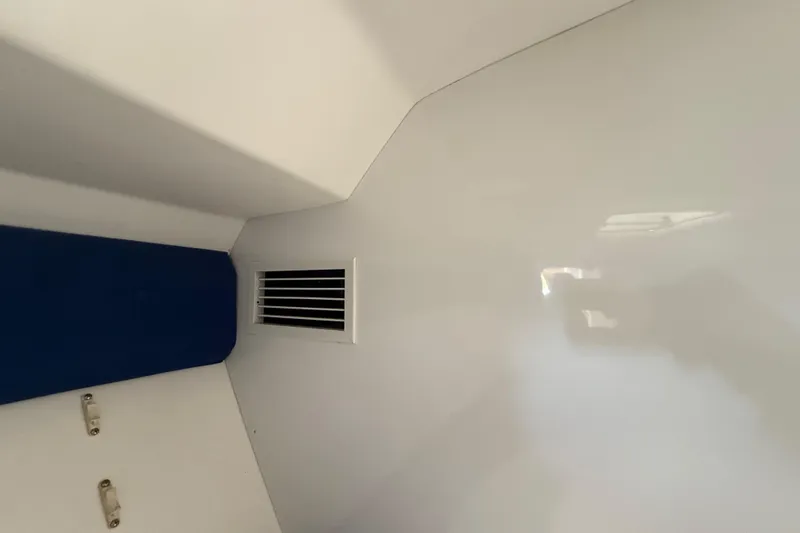 Slide: The Image of Interior view of 2008 Intrepid 377 Walkaround boat with vent and blue cushion. - 159
