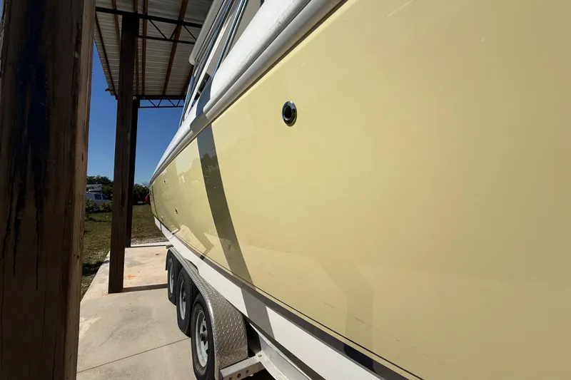 Slide: The Image of 2008 Intrepid 377 Walkaround boat on trailer under shelter, side view. - 16