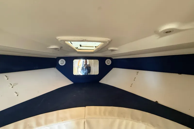 Slide: The Image of Interior cabin of a 2008 Intrepid 377 Walkaround boat, featuring a hatch and speakers. - 164