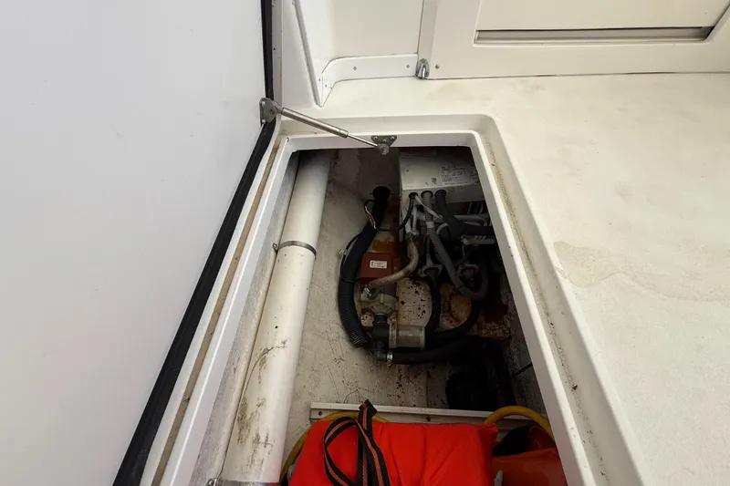 Slide: The Image of 2008 Intrepid 377 Walkaround boat storage compartment with visible wiring and equipment. - 166