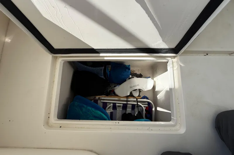 Slide: The Image of Storage compartment on a 2008 Intrepid 377 Walkaround boat, containing various items. - 167