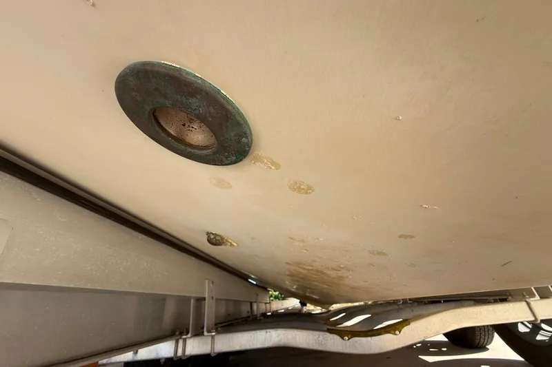 Slide: The Image of 2008 Intrepid 377 Walkaround boat hull underside with visible drain plug. - 193