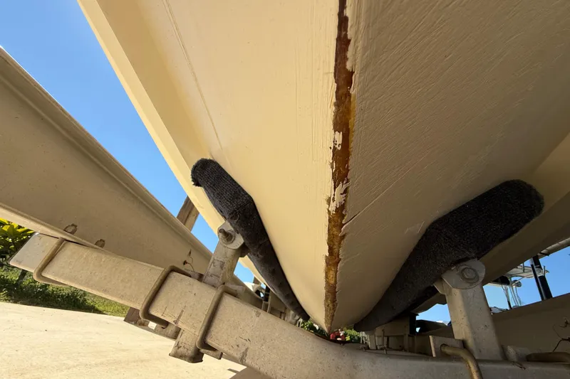 Slide: The Image of 2008 Intrepid 377 Walkaround boat hull on trailer, showing wear and damage. - 197