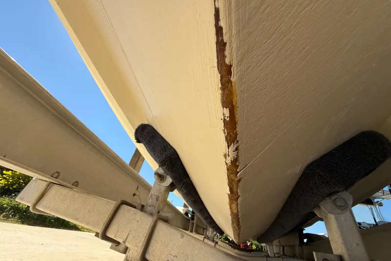 Slide: The Image of 2008 Intrepid 377 Walkaround boat hull on trailer, showing wear and damage. - 198