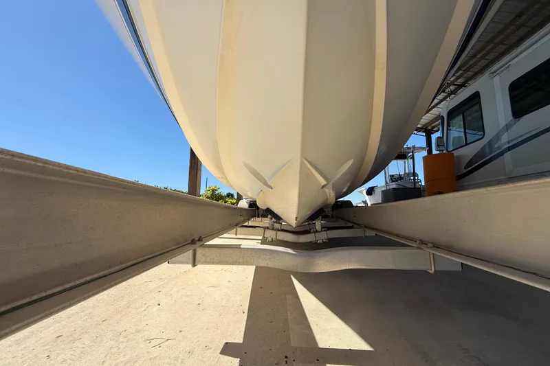 Slide: The Image of 2008 Intrepid 377 Walkaround boat on trailer, viewed from below, under clear blue sky. - 202