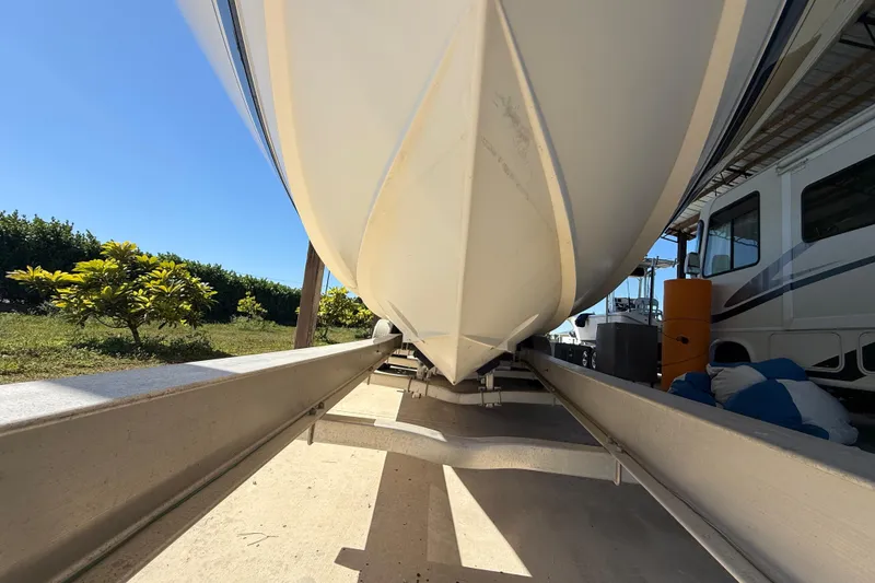 Slide: The Image of 2008 Intrepid 377 Walkaround boat on trailer, viewed from below, sunny day. - 203