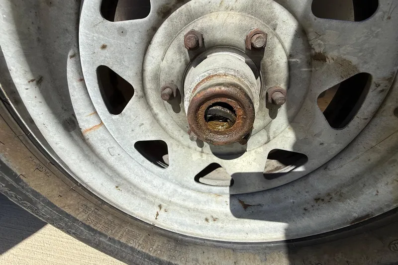 Slide: The Image of Rusty wheel hub on a 2008 Intrepid 377 Walkaround trailer, showing wear and corrosion. - 206