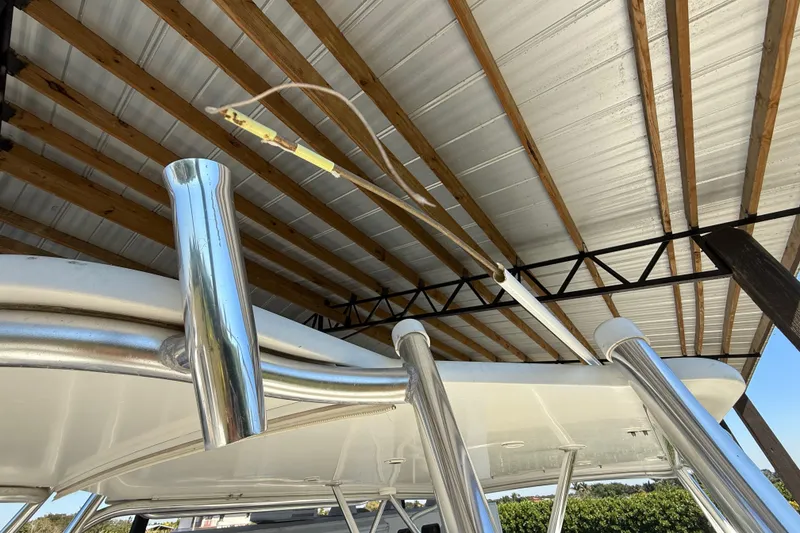 Slide: The Image of 2008 Intrepid 377 Walkaround boat under metal roof with stainless steel fixtures. - 210